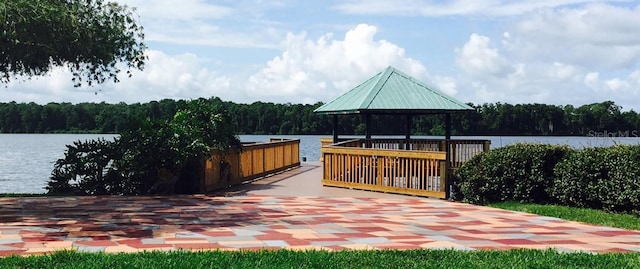 deck featuring a gazebo and a water view