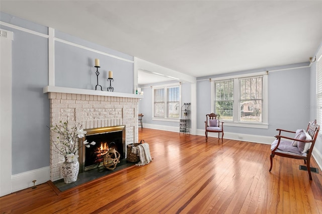 living area featuring a fireplace and wood-type flooring