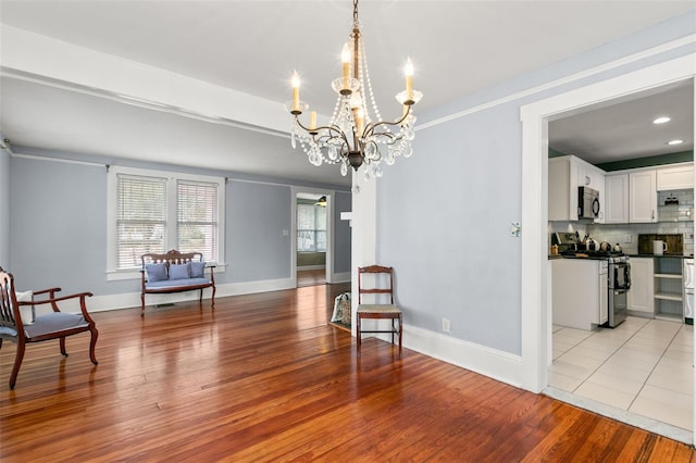 interior space featuring a notable chandelier and light wood-type flooring