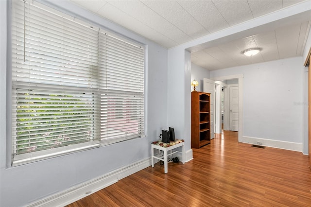 spare room with hardwood / wood-style floors