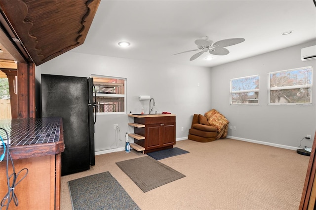 misc room with ceiling fan, a wealth of natural light, and light colored carpet