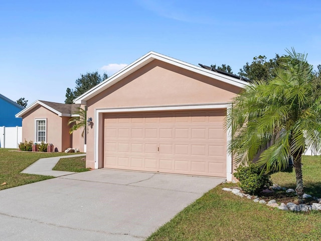 ranch-style home with solar panels, a front lawn, and a garage