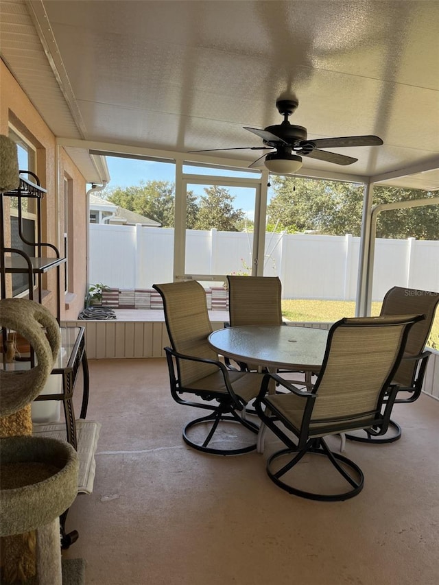 sunroom / solarium featuring ceiling fan