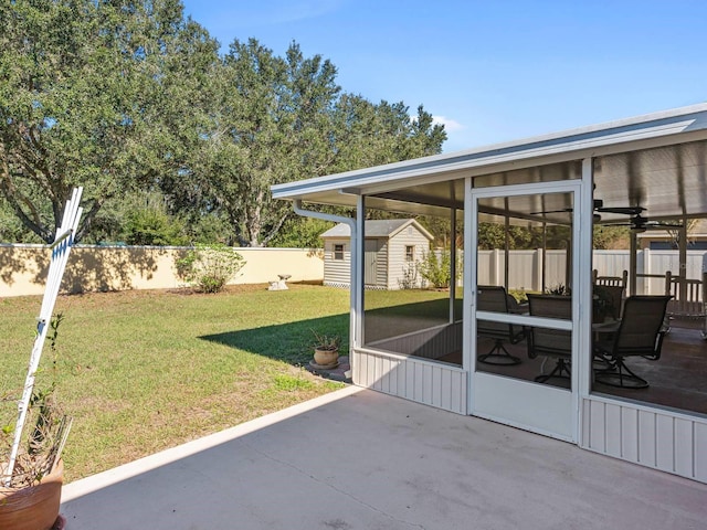 view of patio with ceiling fan, a sunroom, and a shed