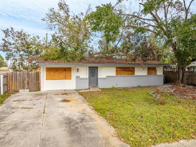 single story home featuring a front lawn