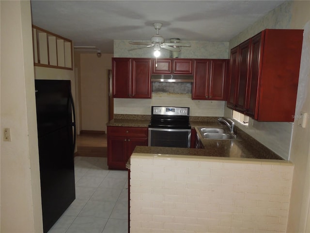 kitchen with black refrigerator, sink, kitchen peninsula, light tile patterned floors, and stainless steel electric range