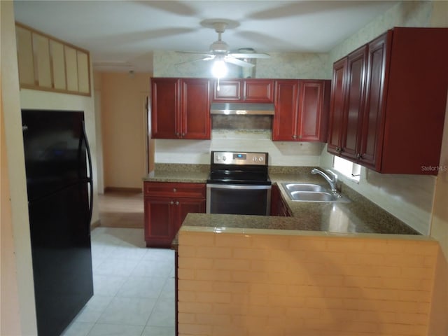 kitchen featuring stainless steel range with electric cooktop, kitchen peninsula, black fridge, light tile patterned flooring, and sink