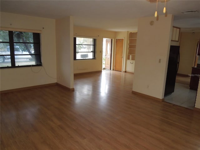 empty room with wood-type flooring