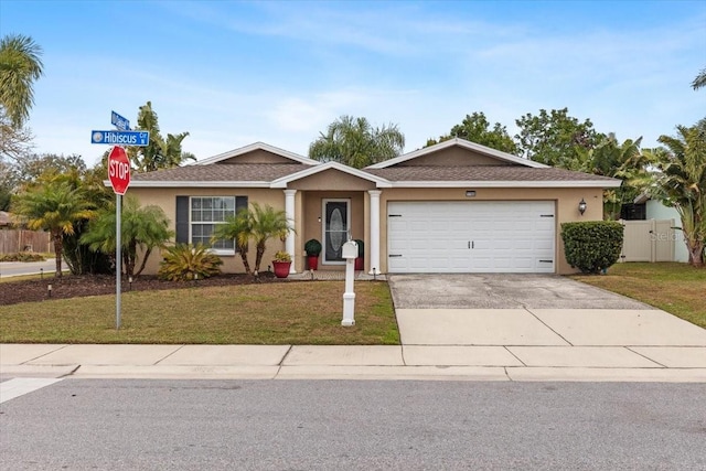 single story home with a front yard and a garage