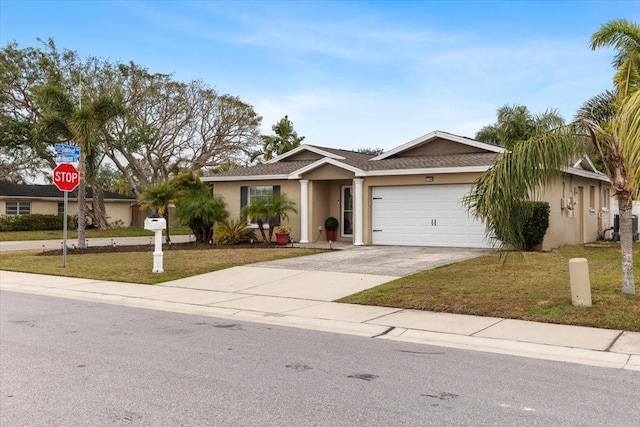 ranch-style house featuring a garage and a front lawn