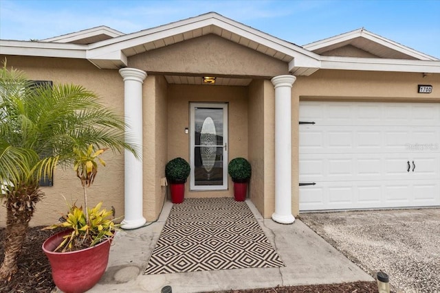 view of exterior entry with a garage