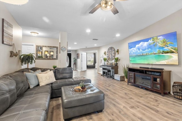 living room with ceiling fan and light hardwood / wood-style floors