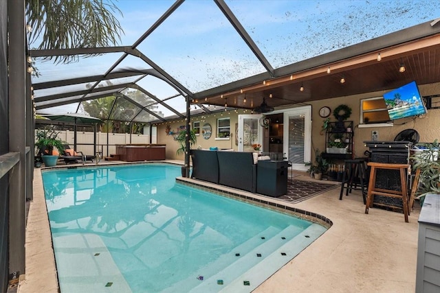 view of pool featuring a patio area, a lanai, a hot tub, and an outdoor hangout area