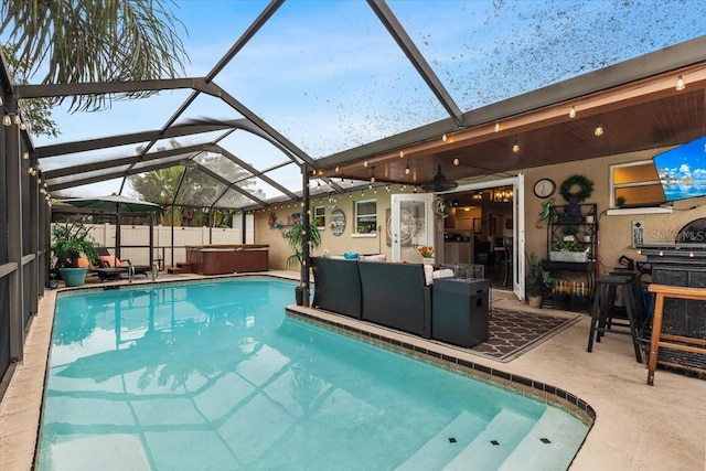 view of swimming pool featuring a patio area, glass enclosure, a hot tub, and an outdoor living space