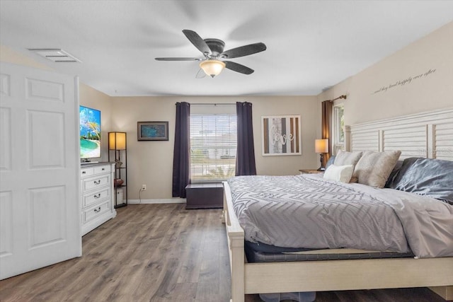 bedroom with ceiling fan and hardwood / wood-style flooring