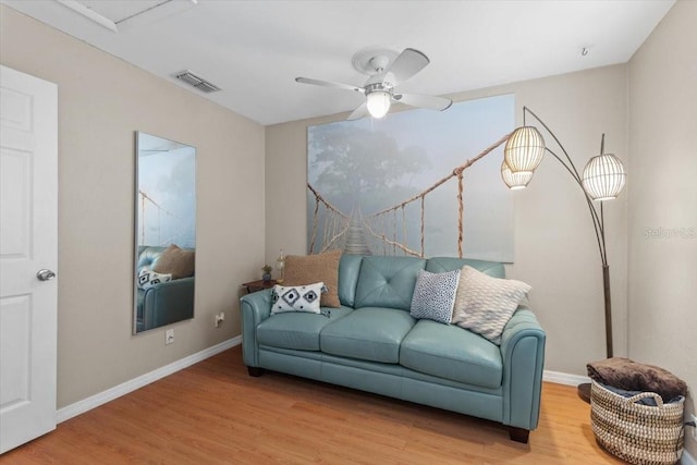 living room with wood-type flooring and ceiling fan