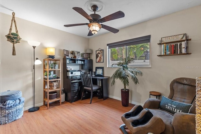 home office with ceiling fan and hardwood / wood-style floors