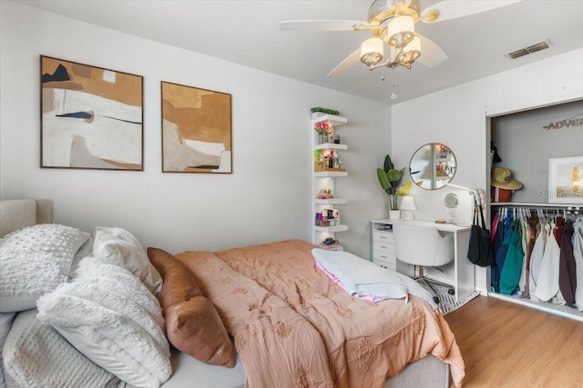 bedroom with hardwood / wood-style floors and ceiling fan