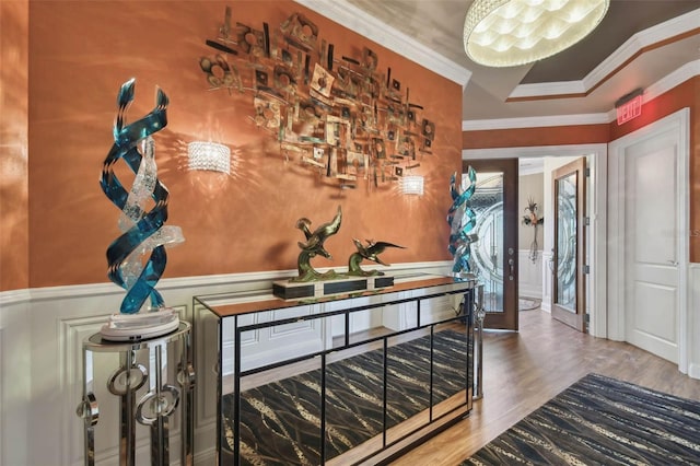 entrance foyer featuring wood-type flooring and crown molding