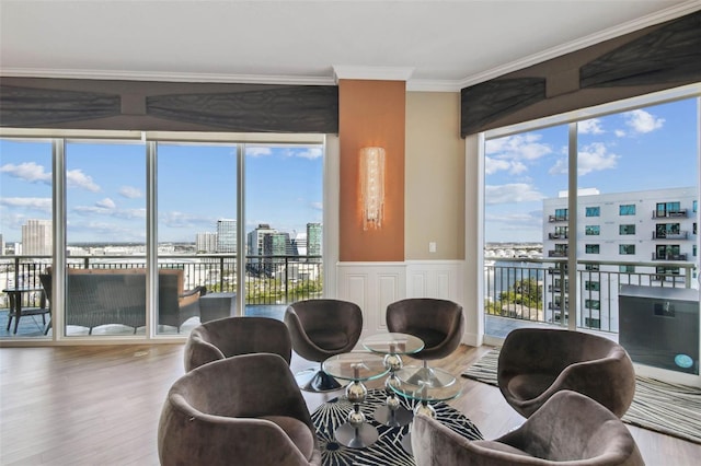 dining space with hardwood / wood-style flooring, a water view, and crown molding