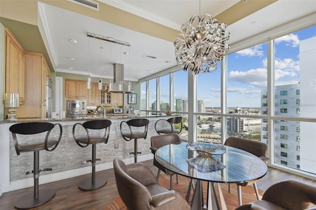 dining area with floor to ceiling windows, crown molding, a healthy amount of sunlight, and hardwood / wood-style flooring