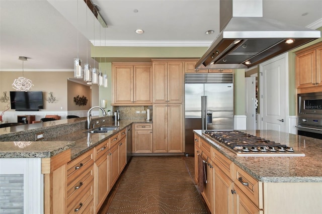 kitchen featuring island exhaust hood, built in appliances, dark stone counters, and sink