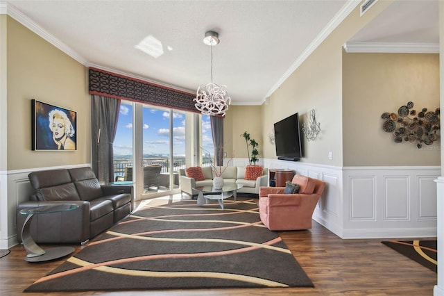 living room with a chandelier, a textured ceiling, dark hardwood / wood-style flooring, and crown molding