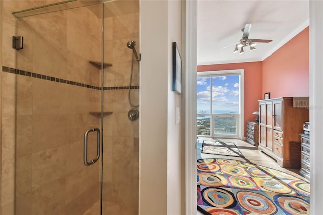 bathroom featuring crown molding, ceiling fan, and an enclosed shower