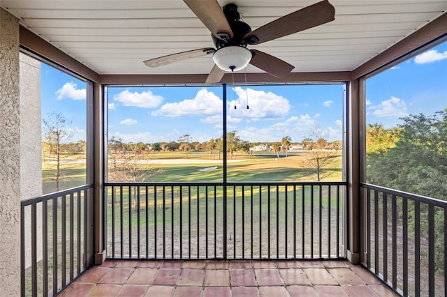 unfurnished sunroom with ceiling fan