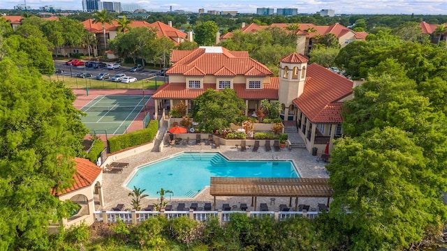 view of pool with a pergola and tennis court