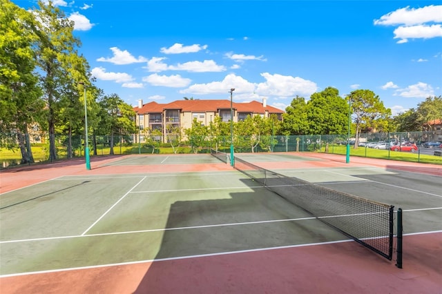 view of tennis court featuring basketball hoop