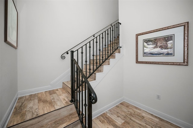 stairway featuring wood-type flooring