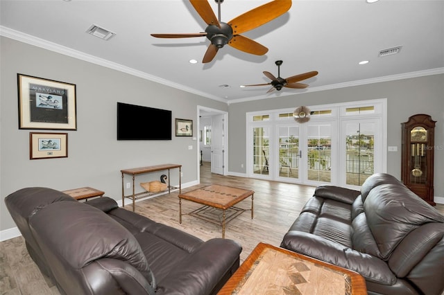 living room featuring light hardwood / wood-style floors and ornamental molding