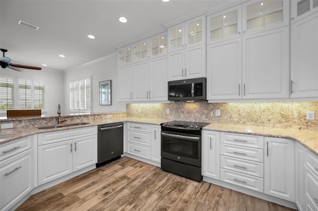 kitchen featuring white cabinetry, sink, ceiling fan, stainless steel appliances, and backsplash