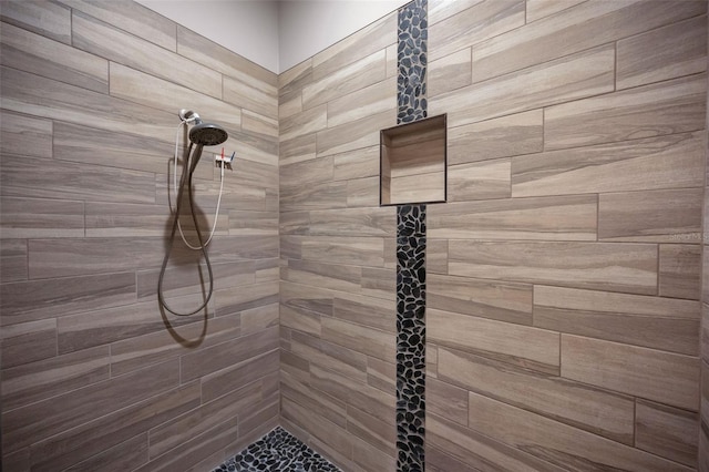 bathroom with tiled shower