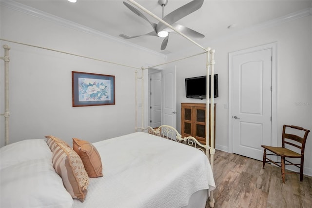 bedroom with light hardwood / wood-style flooring, ceiling fan, and crown molding