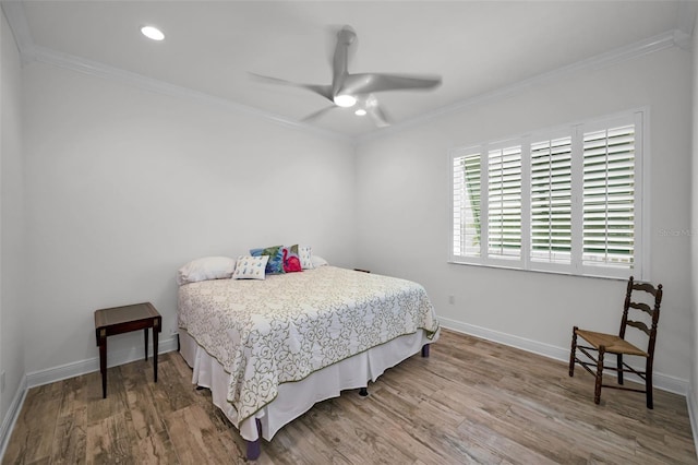 bedroom with ceiling fan, wood-type flooring, and ornamental molding