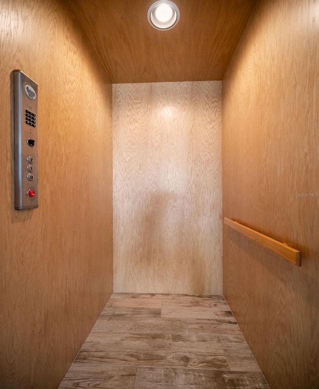 interior space featuring wood ceiling and elevator