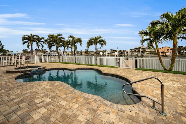 view of swimming pool with a water view and a patio