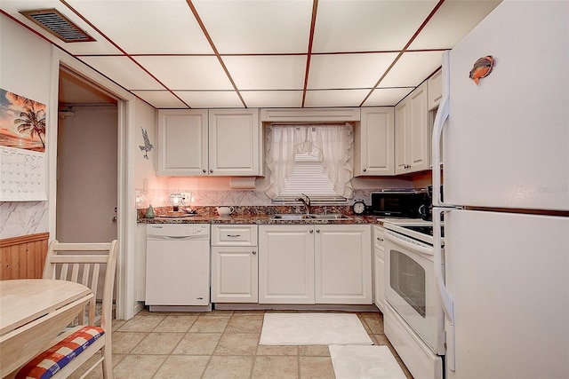 kitchen with sink, white cabinets, a drop ceiling, and white appliances