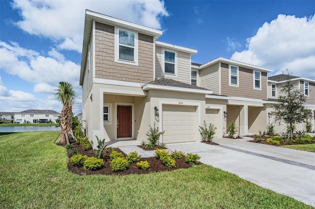 view of front of home with a front lawn and a garage