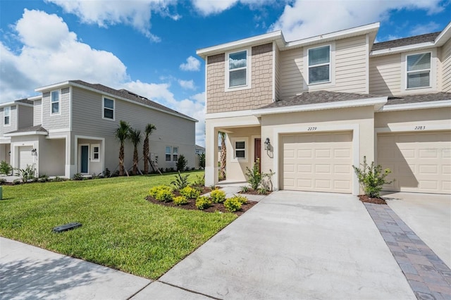 view of property with a front lawn and a garage