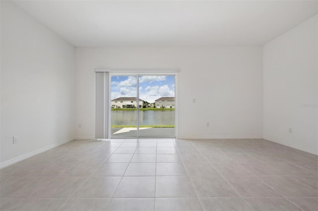 tiled empty room with a water view