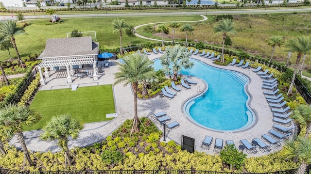 view of swimming pool featuring a pergola, a patio area, and a lawn