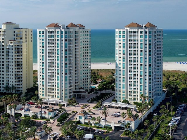 view of property with a water view and a view of the beach