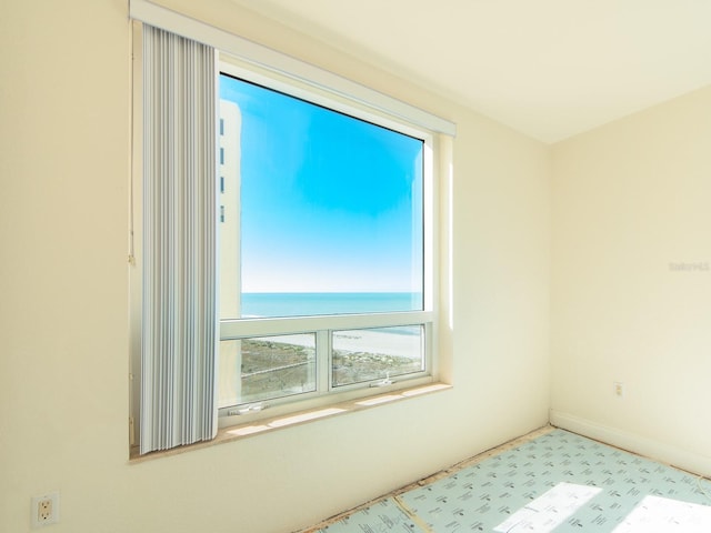 unfurnished room with a water view and a healthy amount of sunlight