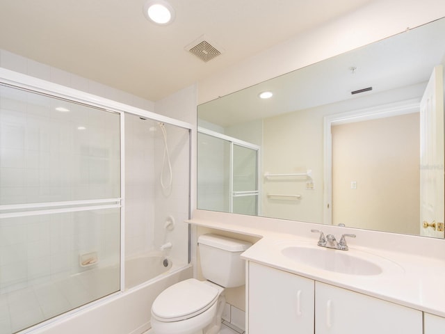 full bathroom featuring shower / bath combination with glass door, vanity, and toilet