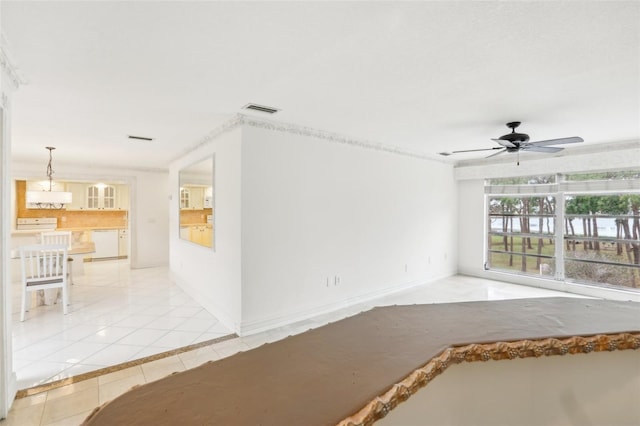 tiled spare room with ceiling fan