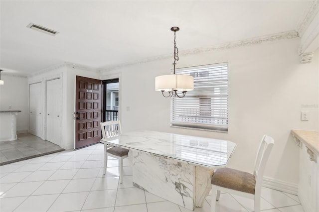 tiled dining space featuring a chandelier