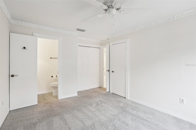 unfurnished bedroom featuring ceiling fan, light colored carpet, connected bathroom, and crown molding